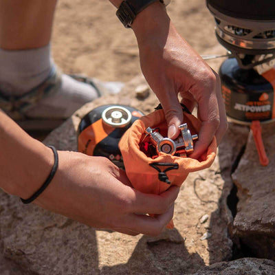 A person taking the Jetboil MightyMo out of the carrying bag