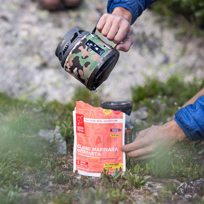 Person Pouring water from the Jetboil MiniMo into a MRE pouch