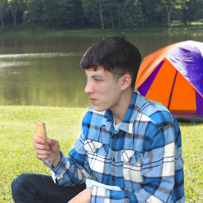 Man eating 72 HRS food ration bar outdoors