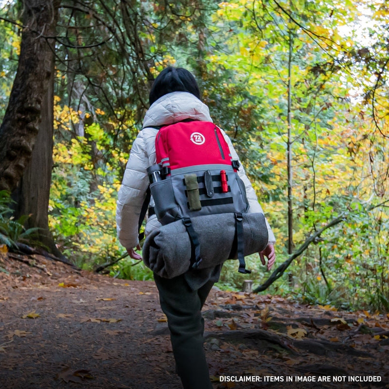 woman carrying 72HRS Red Deluxe Backpack in the forest