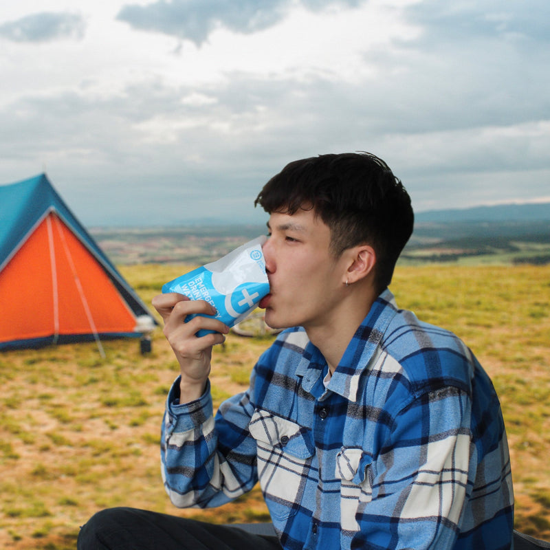 man drinking 72HRS water pouch in outdoors
