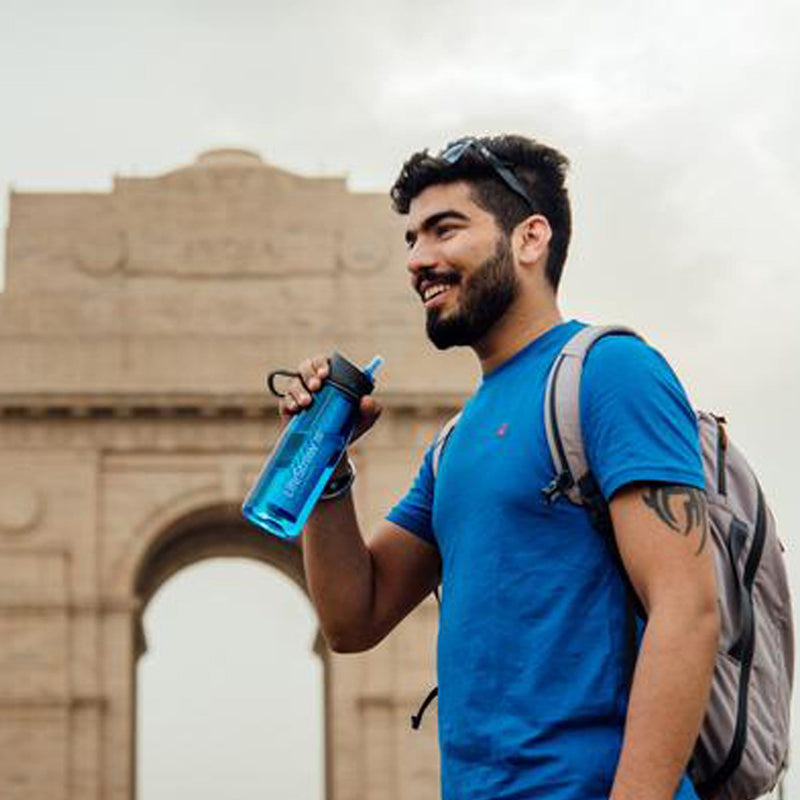 man travelling and using LifeStraw Go Water Bottle