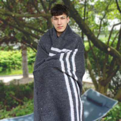 man wrapped in Gray and White Cotton Blanket outdoors standing