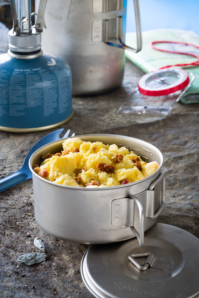 scrambled eggs with bacon served on metal bowl